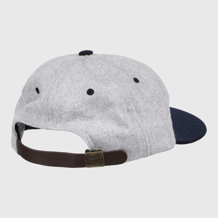 The EFF University of Nevada Wolf Pack Mascot Collegiate Wool Ballcap is shown from the back in grey and navy, featuring a brown adjustable strap with a brass-colored buckle. This is an officially licensed college vault item.