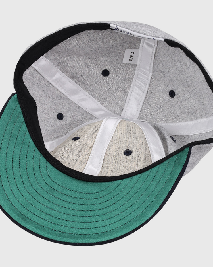 The image shows the inside of an EFF University of Nevada Wolf Pack Mascot Collegiate Wool Ballcap featuring a gray finish, green underbrim, black edge lining, white seams, and a size 7 1/8 label—an officially licensed college vault item.