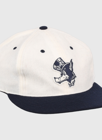 The EFF University of Nevada Wolf Pack Mascot Collegiate Wool Ballcap in white features a navy brim and button, plus an embroidered Wolf Pack logo—perfect for standout collegiate style.