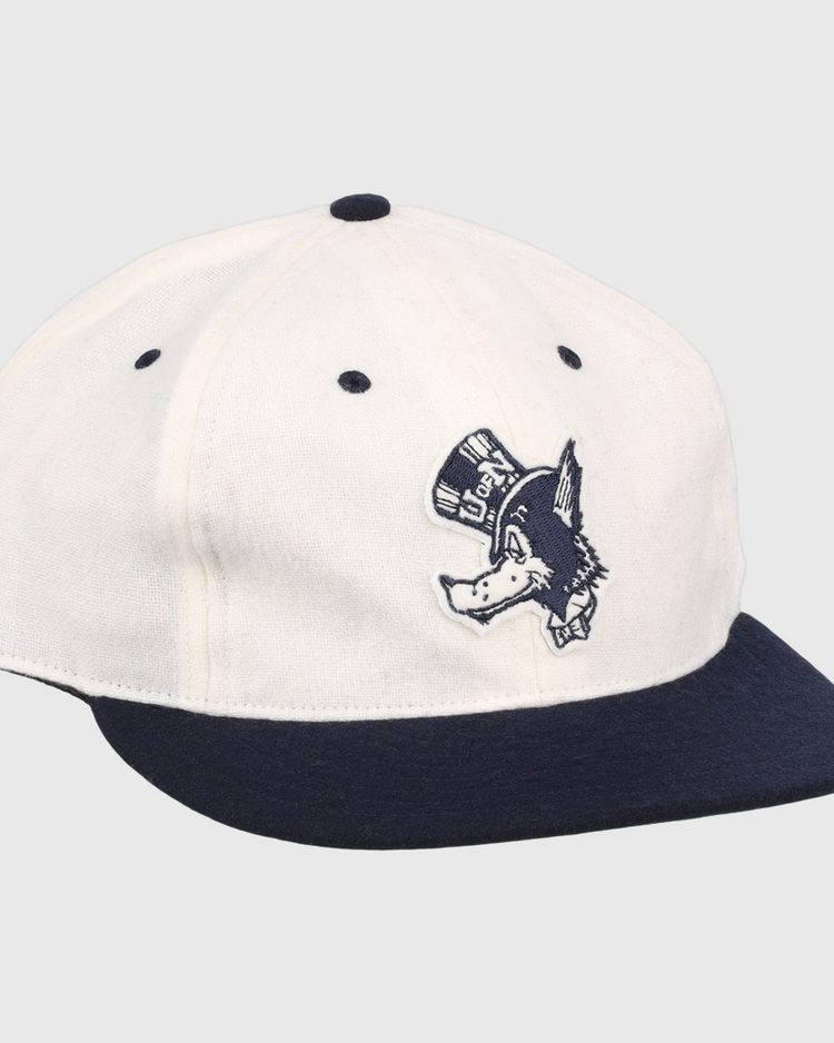 The EFF University of Nevada Wolf Pack Mascot Collegiate Wool Ballcap in white features a navy brim and button, plus an embroidered Wolf Pack logo—perfect for standout collegiate style.