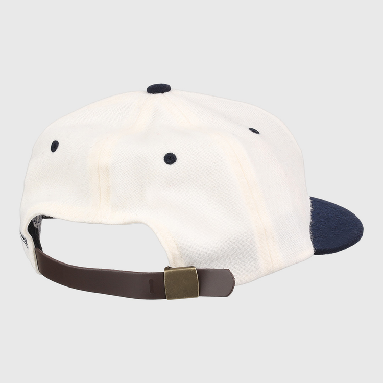 A white University of Nevada Wolf Pack Mascot Collegiate Wool Ballcap by EFF, viewed from the back, features a navy brim and a brown adjustable strap with brass buckle for a classic vintage touch.