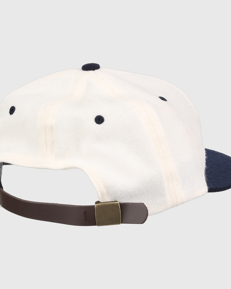 A white University of Nevada Wolf Pack Mascot Collegiate Wool Ballcap by EFF, viewed from the back, features a navy brim and a brown adjustable strap with brass buckle for a classic vintage touch.