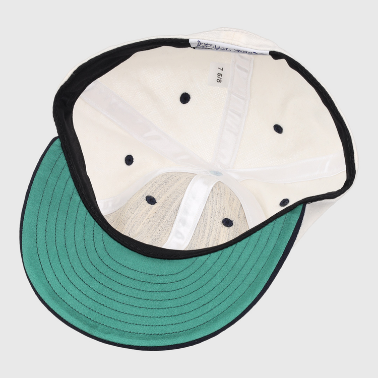 The image shows the inside of an EFF University of Nevada Wolf Pack Mascot Collegiate Wool Ballcap in white, featuring a green underbrim, black edge trim, size tag “7 5/8,” black ventilation holes, and stitched interior panels.