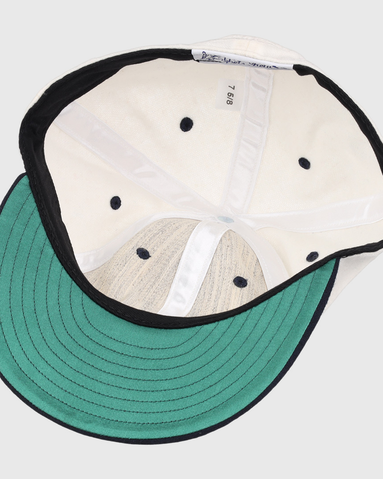 The image shows the inside of an EFF University of Nevada Wolf Pack Mascot Collegiate Wool Ballcap in white, featuring a green underbrim, black edge trim, size tag “7 5/8,” black ventilation holes, and stitched interior panels.