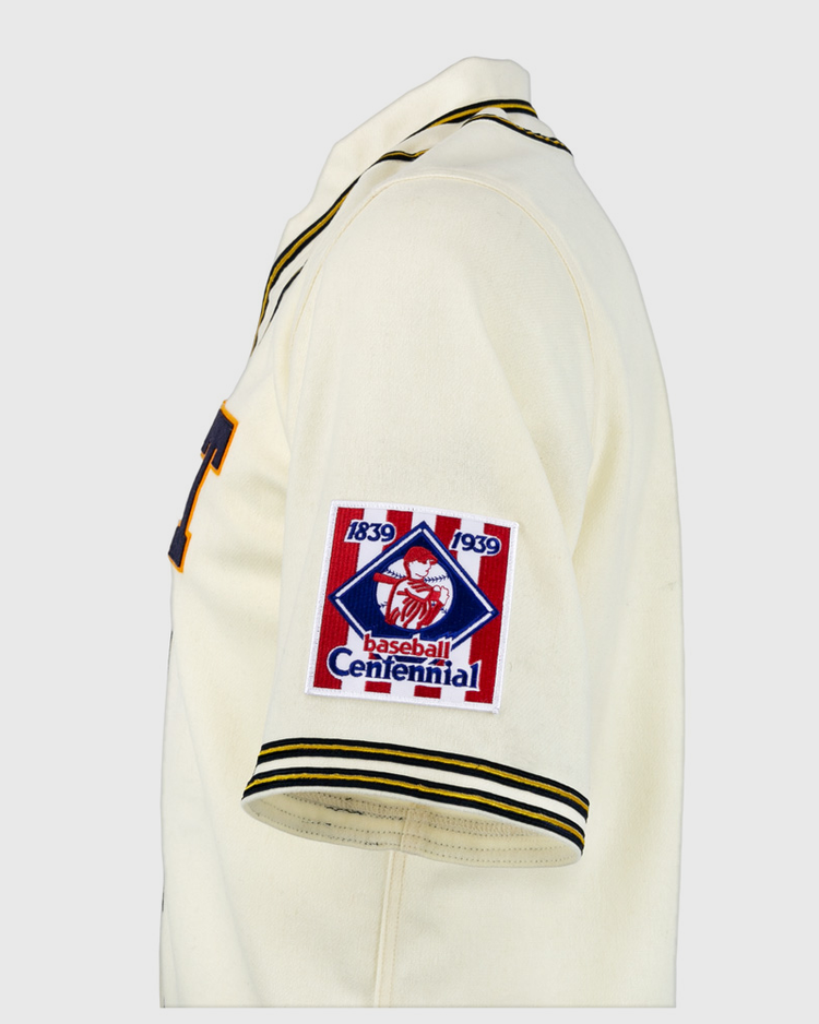 The EFF University of Pittsburgh 1939 Jersey is a cream authentic reproduction with black and yellow trim and a Baseball Centennial 1839-1939 patch on the left sleeve—ideal for collegiate baseball fans and collectors.