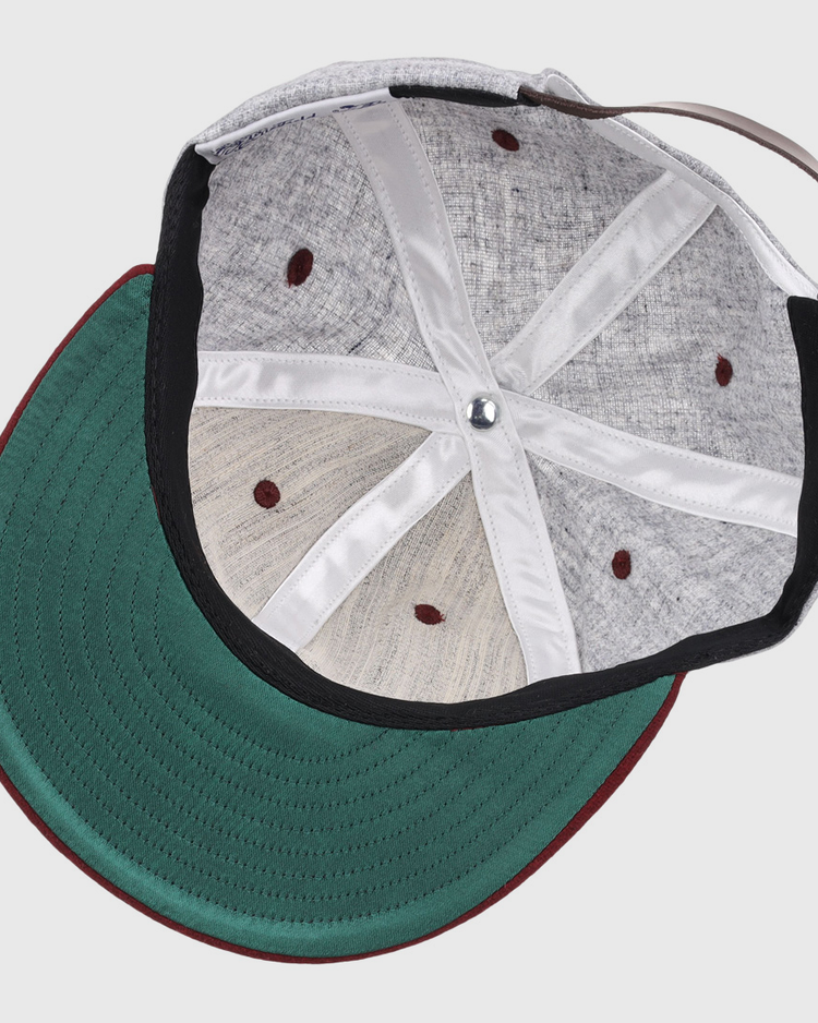 Interior view of the EFF University of South Carolina 1949 Vintage Ballcap shows a green underbrim, maroon edge, visible interior panels and seams, plus a brown adjustable strap.