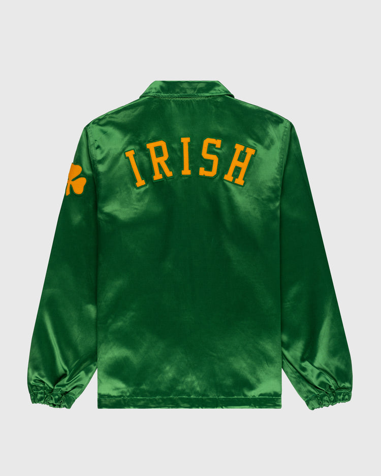 The EFF University of Notre Dame Satin Windbreaker Jacket is a shiny green jacket with IRISH in bold yellow letters on the back and a yellow shamrock on the left sleeve, perfect for fans who love classic style.