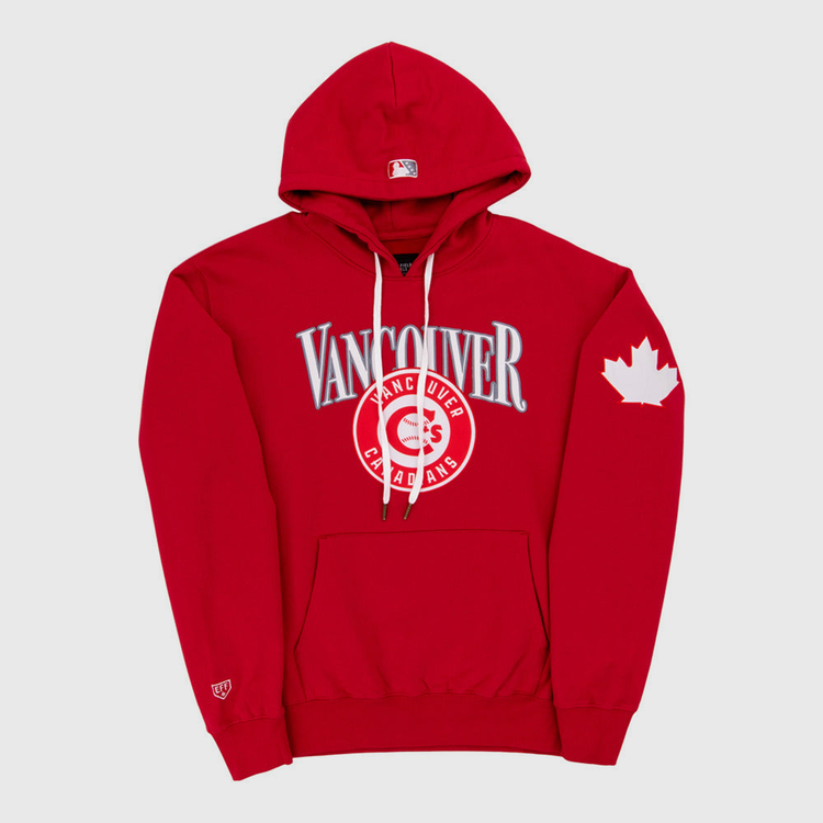 The Ebbets Field Vancouver Canadians MiLB Cotton Hooded Sweatshirt features red fabric, “Vancouver” and “Canadians” on the chest, a maple leaf on the left sleeve, white drawstrings, and a front pocket.