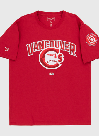 The Vancouver Canadians MiLB Fashion Cotton Short Sleeve Tee by Ebbets Field features a red design with a Vancouver logo and baseball graphic on the chest, plus a circular Vancouver Canadians patch on the left sleeve.