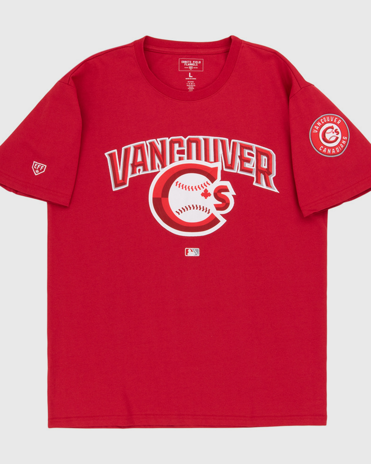 The Vancouver Canadians MiLB Fashion Cotton Short Sleeve Tee by Ebbets Field features a red design with a Vancouver logo and baseball graphic on the chest, plus a circular Vancouver Canadians patch on the left sleeve.