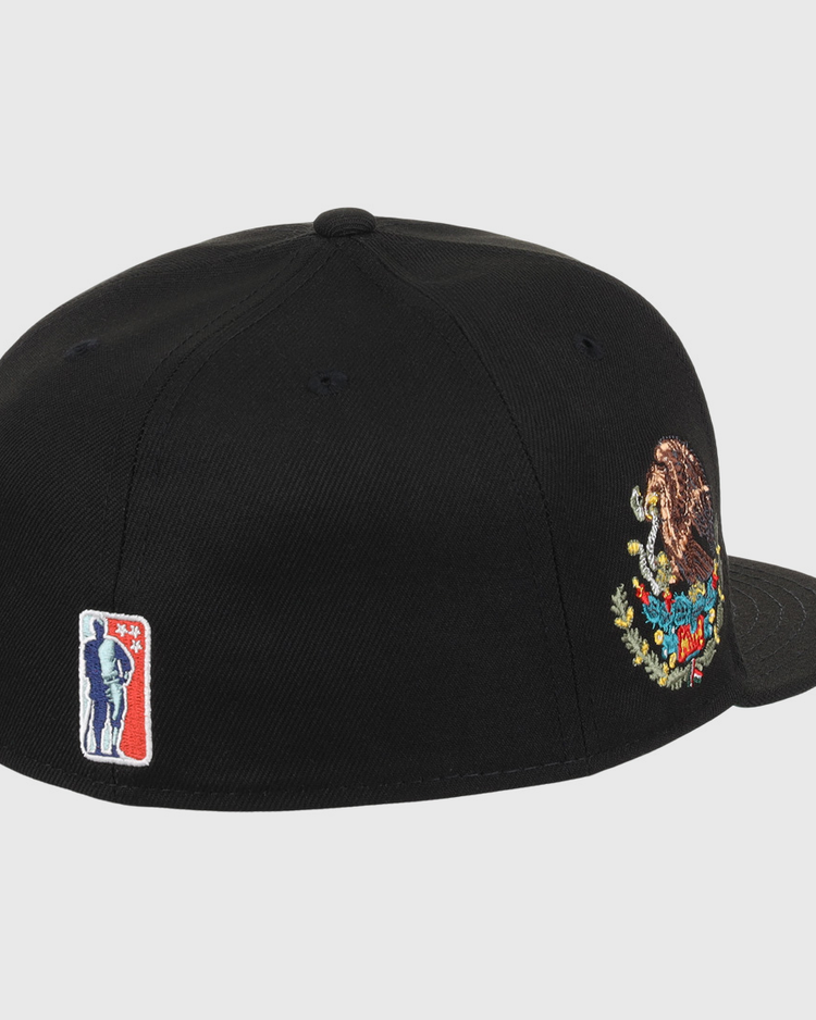 The EFF Veracruz Azules NLB Team Color Fitted Ballcap is black with an embroidered Mexico coat of arms on the side and a small red, white, and blue baseball player logo near the back.