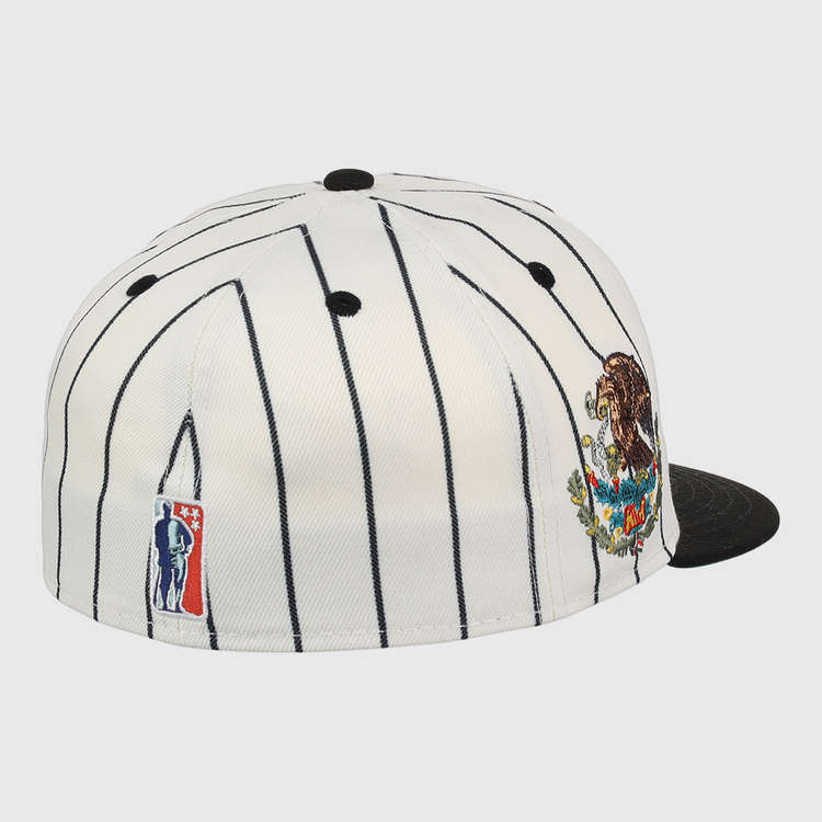 The EFF Veracruz NLB Pinstripe Fitted Ballcap is a white cap with thin black pinstripes, a black brim, a colorful bear and mountains patch on the side, and an embroidered NBA logo on the back.