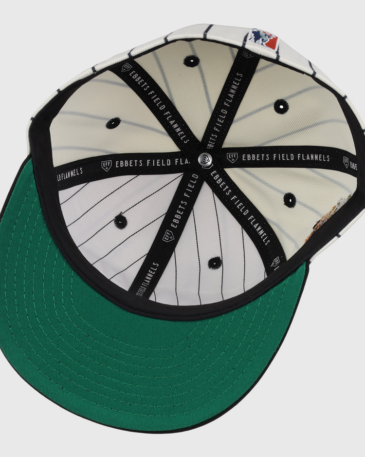 The underside of the Veracruz NLB Pinstripe Fitted Ballcap by EFF features a green brim, white inner panels with black pinstripes, black button details, and black bands labeled EBBETS FIELD FLANNELS.