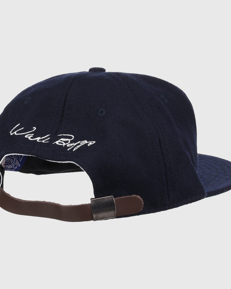 The Ebbets Field Flannels Wade Boggs Signature Series Ballcap in navy wool is shown from the back, featuring a brown adjustable strap and Wade Boggs’s white embroidered signature above the opening.