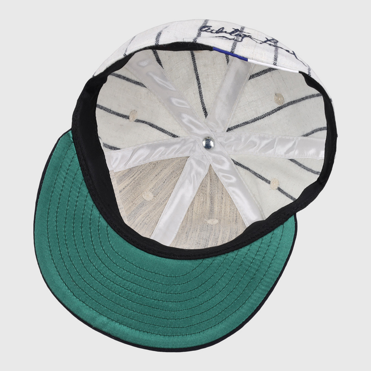 The underside of the Ebbets Field Flannels Whitey Ford Signature Series Ballcap features a green brim, white interior with black pinstripes, silver top button, and visible stitching—hallmarks of authentic vintage Yankees style.