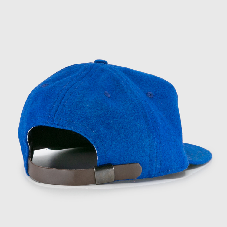 The EFF Wichita Falls Spudders 1956 Vintage Ballcap in royal blue is shown from the back, highlighting its dark brown adjustable strap and metal clasp.