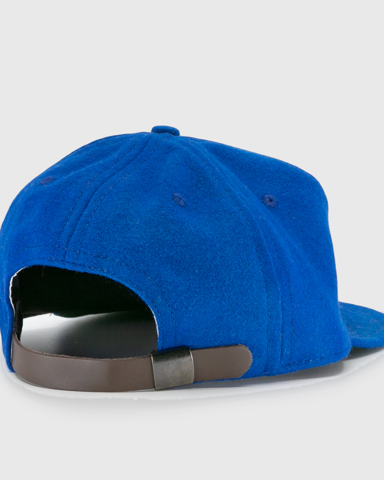 The EFF Wichita Falls Spudders 1956 Vintage Ballcap in royal blue is shown from the back, highlighting its dark brown adjustable strap and metal clasp.