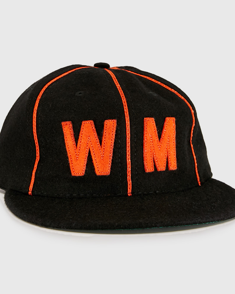 The EFF Wichita Monrovians 1925 Vintage Ballcap is a black cap with bright orange piping and a large orange embroidered WM on the front, inspired by the classic teams original design.