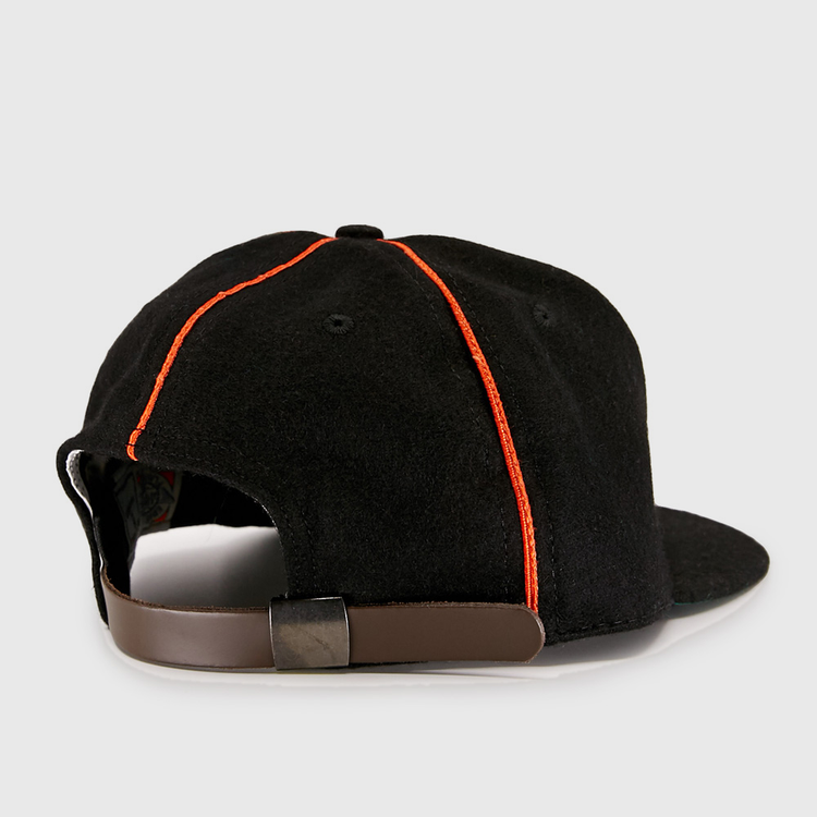 The EFF Wichita Monrovians 1925 Vintage Ballcap features red stitching and a brown adjustable strap with metal clasp, shown from the back. Inspired by classic Negro Leagues style.
