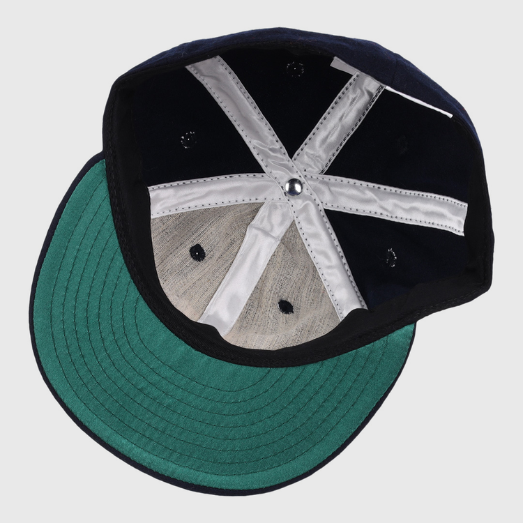 The image shows the inside of an EFF Winston-Salem Red Sox 1966 Vintage Ballcap, featuring a green brim and white stitching. The cap is upside down, displaying its structure and fabric panels.