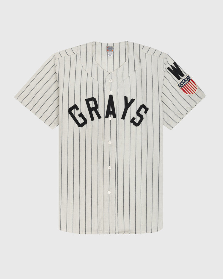 The Ebbets Field Flannels Homestead Grays 1944 Authentic Wool Home Baseball Jersey features white fabric with thin black pinstripes, bold GRAYS lettering, and a left sleeve patch honoring Negro Leagues Baseball Museum history.