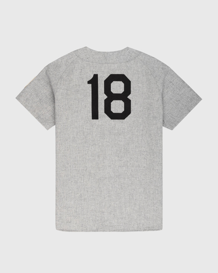 The Ebbets Field Flannels Homestead Grays 1944 Authentic Wool Road Baseball Jersey is light gray, features short sleeves, and has the number 18 in bold black on the back. Displayed on a plain white background.