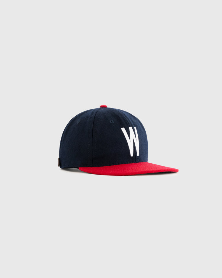 The Ebbets Field Flannels Wichita Braves 1957 Authentic Wool Ballcap features a navy crown, red brim and button, plus a bold white W on the front. Shown on a plain light gray background.