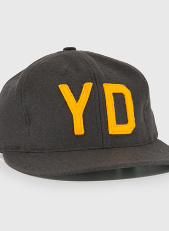 The EFF Young Democrats 1972 Vintage Inspired Ballcap is a dark grey wool six-panel cap with a curved brim and yellow Y and D embroidery, capturing classic Little League baseball style.