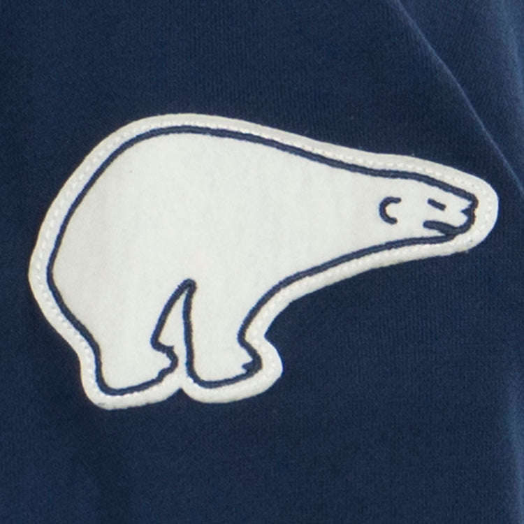 A white polar bear outline patch with blue stitching, inspired by Polar brand beer, is sewn onto the dark blue Cerveceria Polar French Terry Script Hooded Sweatshirt by EFF.
