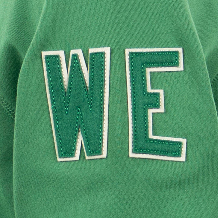 EFF’s Denver White Elephants French Terry Script Hooded Sweatshirt features green fabric and large, white-outlined WE letters, echoing the iconic baseball style of teams like the White Elephants.
