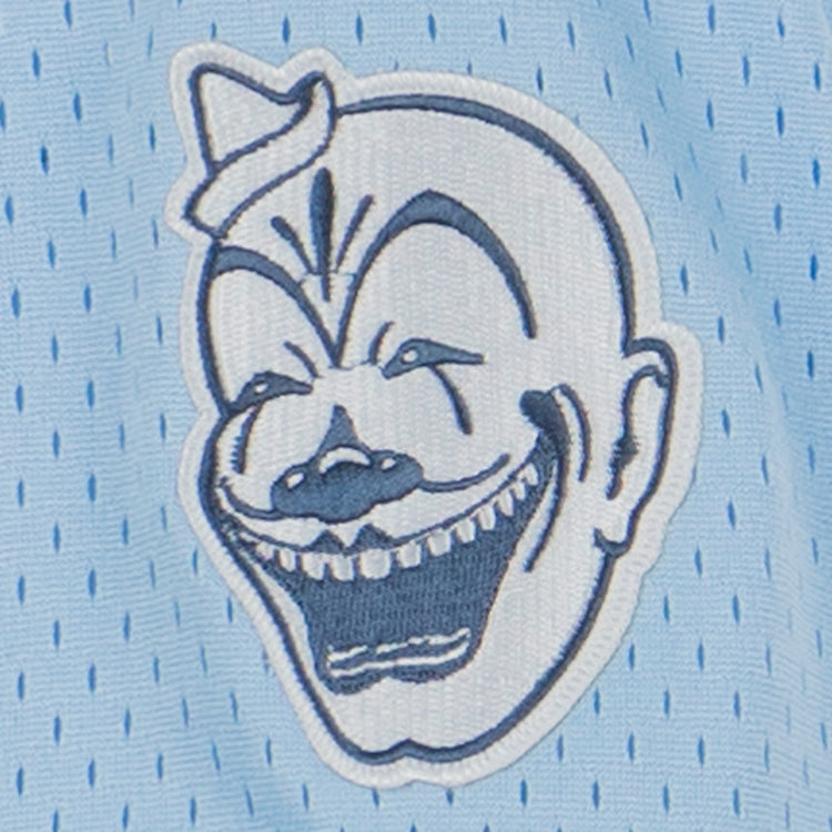 An embroidered cartoon clown face with bold features decorates this EFF Negro League Allover Vintage Inspired NL Replica V-Neck Mesh Jersey in light blue, echoing the spirited designs of classic Negro Leagues Baseball uniforms.