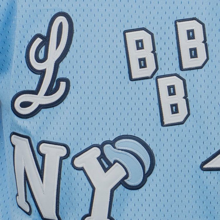 A close-up of the EFF Negro League Allover Vintage Inspired NL Replica V-Neck Mesh Jersey in light blue shows white and navy embroidered L, NY, and multiple B letters on breathable mesh.