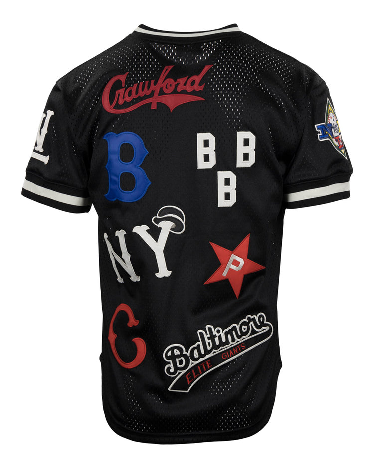 The EFF Negro League Allover Vintage Inspired NL Replica V-Neck Mesh Jersey in black features white trim and colorful team patches, celebrating historic Negro League Baseball teams, all crafted in classic Ebbets Field Flannels style.