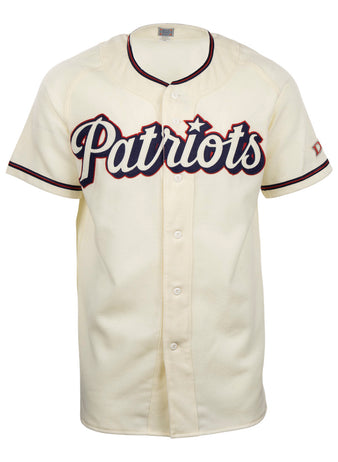 The EFF Dallas Baptist University Home Jersey is cream-colored with black and red trim, Patriots in large script on the chest, a flannel-style design, front buttons, and short sleeves.