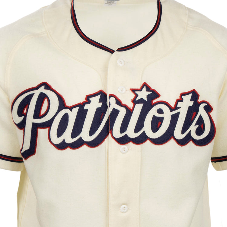 The EFF Dallas Baptist University Home Jersey is a cream Patriots baseball shirt with bold navy script, red outline, and a star over the i, inspired by the classic DBU jersey style.