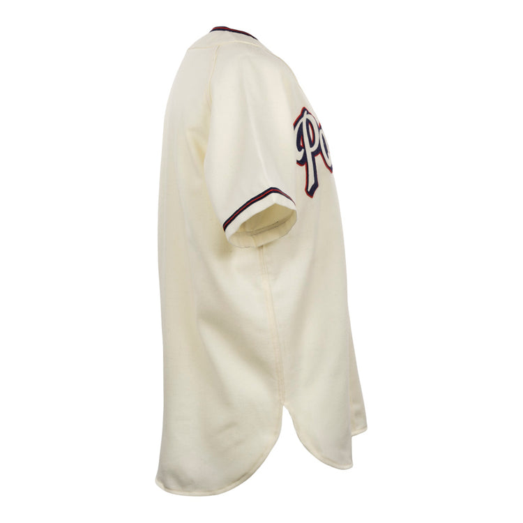 The EFF Dallas Baptist University Home Jersey is shown from the side in cream, with dark sleeve trim and partial lettering across the chest.