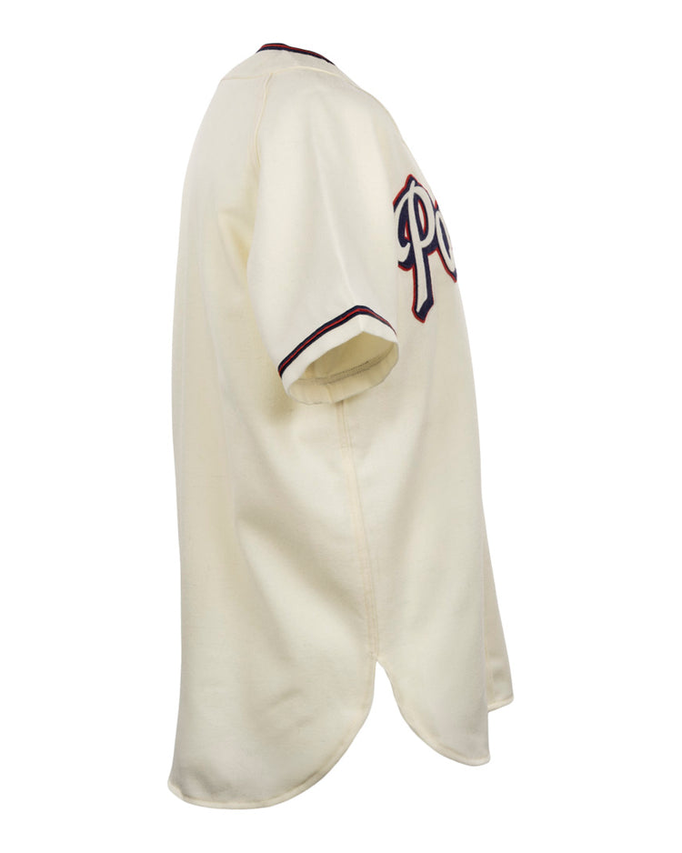 The EFF Dallas Baptist University Home Jersey is shown from the side in cream, with dark sleeve trim and partial lettering across the chest.