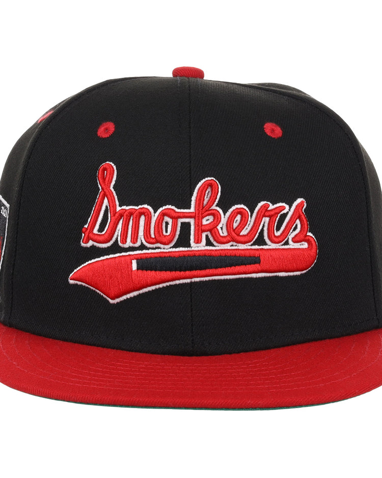 The EFF Tampa Smokers NLB Black and Red Fitted Ballcap features red accents and Smokers embroidered on the front, honoring the historic Tampa Smokers of the Florida International League.