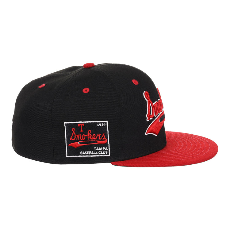 The EFF Tampa Smokers NLB Black and Red Fitted Ballcap features a black crown, flat red brim, Tampa Smokers on the side, and a patch reading T Smokers 1919 Tampa Baseball Club, honoring the teams Florida International League legacy.