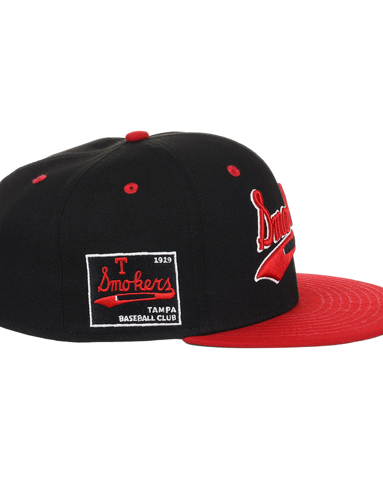 The EFF Tampa Smokers NLB Black and Red Fitted Ballcap features a black crown, flat red brim, Tampa Smokers on the side, and a patch reading T Smokers 1919 Tampa Baseball Club, honoring the teams Florida International League legacy.