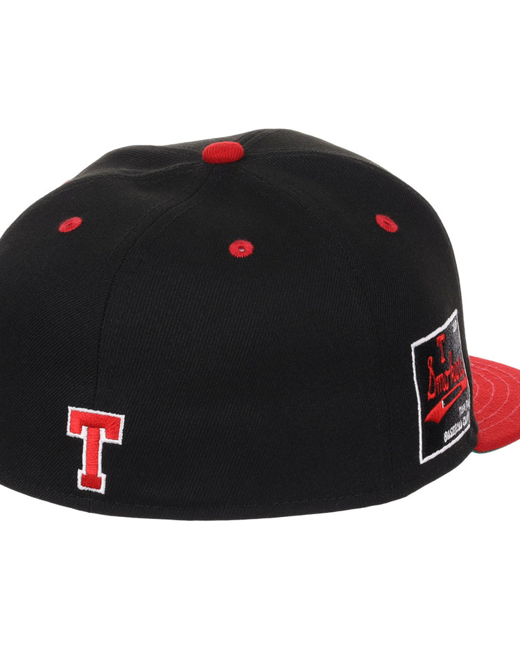 The EFF Tampa Smokers NLB Black and Red Fitted Ballcap features a black crown, red brim, button, and eyelets, a white-outlined red T embroidered on the back, and a black and red side patch inspired by the Florida International League team.