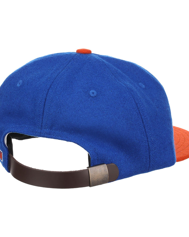 The EFF Morgan State University 1975 Vintage Ballcap is blue with an orange brim and button, shown from the back. It features a dark brown adjustable strap with a metal clasp for comfort and style.