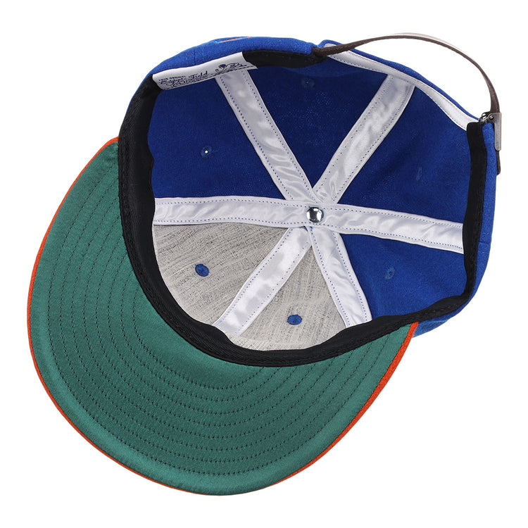 The image shows the inside of the EFF Morgan State University 1975 Vintage Ballcap, featuring a blue exterior, green underside brim, white stitching, and an adjustable back strap.