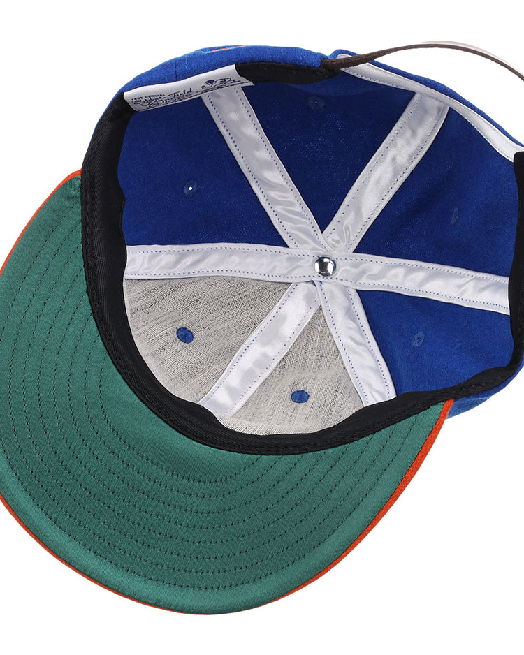 The image shows the inside of the EFF Morgan State University 1975 Vintage Ballcap, featuring a blue exterior, green underside brim, white stitching, and an adjustable back strap.
