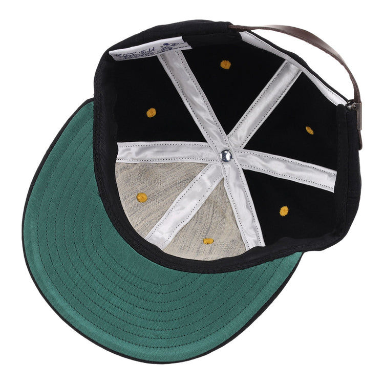 The inside of the EFF University of Central Florida Vintage Ballcap features a black design with a green underside on the brim, white stitched panels, gold rivets, and an adjustable brown strap at the back.