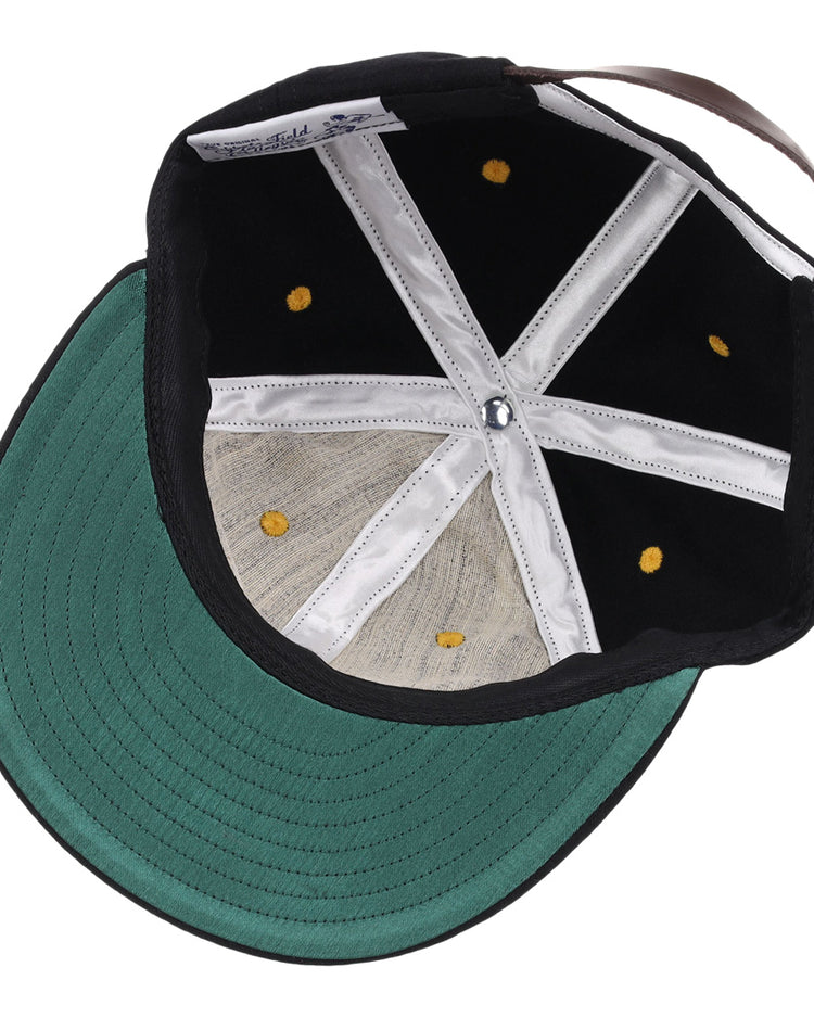 The inside of the EFF University of Central Florida Vintage Ballcap features a black design with a green underside on the brim, white stitched panels, gold rivets, and an adjustable brown strap at the back.