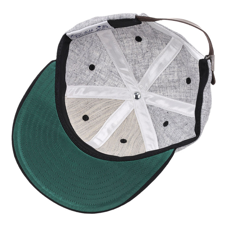 The image shows the inside of an EFF University of Central Florida Mascot Vintage Ballcap featuring a grey design, green brim, black ventilation holes, white fabric lining, and an adjustable brown strap at the back.