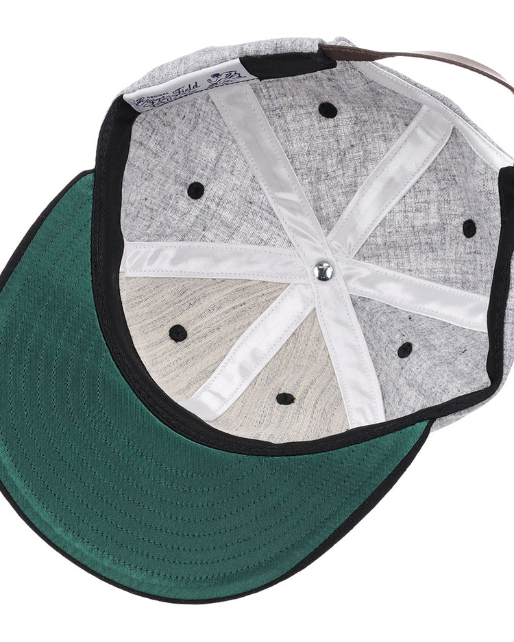 The image shows the inside of an EFF University of Central Florida Mascot Vintage Ballcap featuring a grey design, green brim, black ventilation holes, white fabric lining, and an adjustable brown strap at the back.