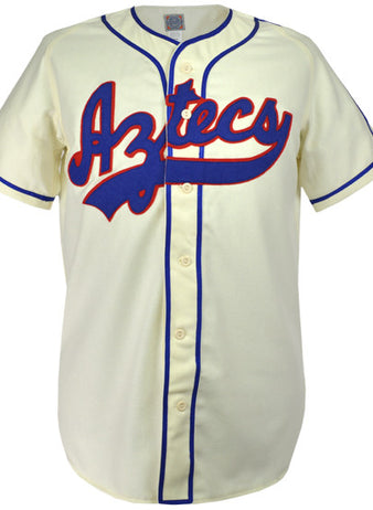 The EFF Mexico City Aztecs 1946 Home Jersey is cream-colored with blue piping, Aztecs in red and blue script across the chest, button front closure, and classic short sleeves.