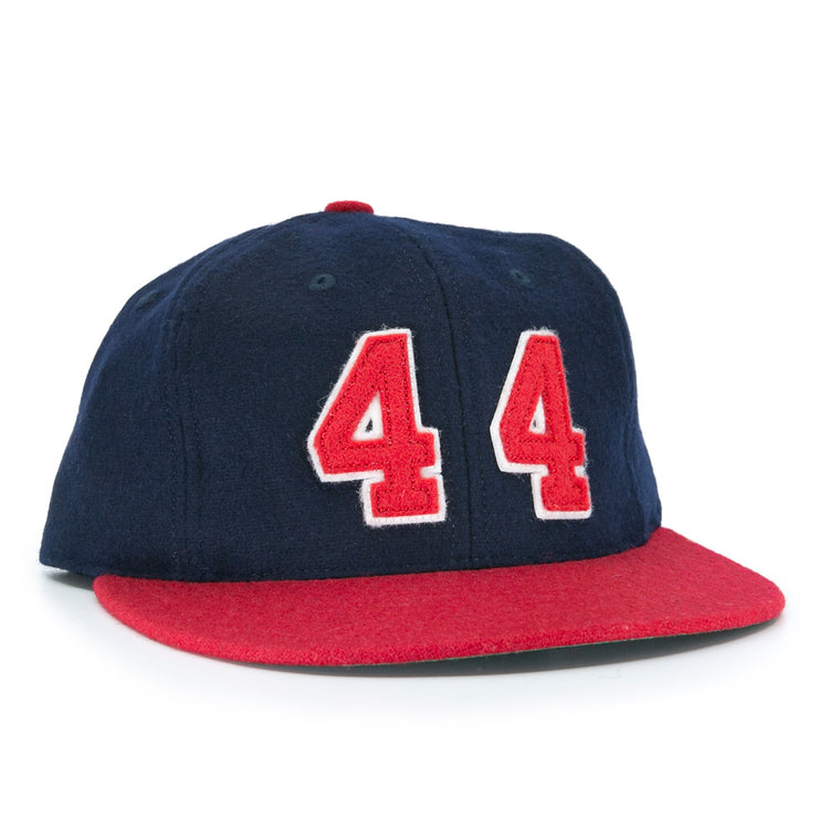 The Ebbets Field Flannels Hank Aaron 1957 Signature Series Ballcap is a vintage-style wool cap in navy with a red brim and bold red-and-white “44” on the front, inspired by baseball legends and proudly made in the USA.